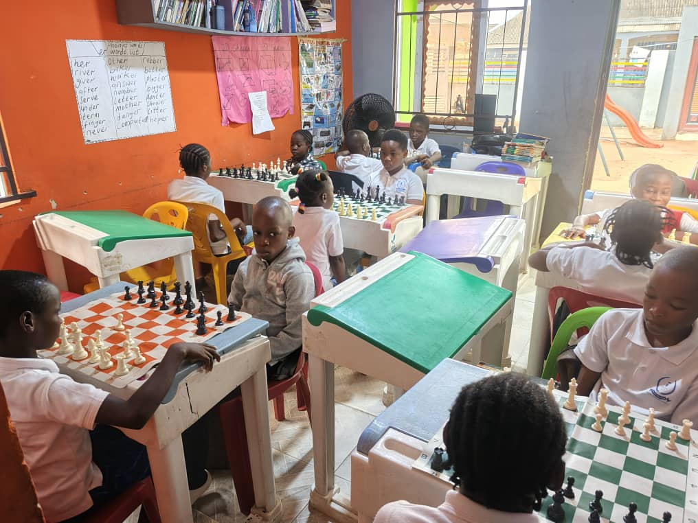 Pupils playing supervised chess games